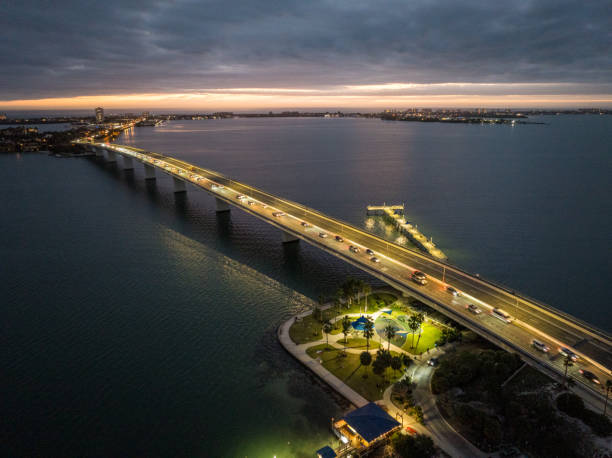 Illuminated Bridge Over River Against Sky At Night