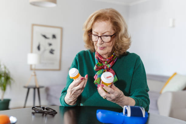istock Senior woman reading medicine instruction on packaging 1975937977