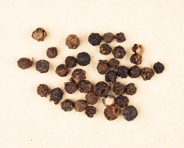 black pepper grains - directly above macro pepper black peppercorn stock-fotos und bilder