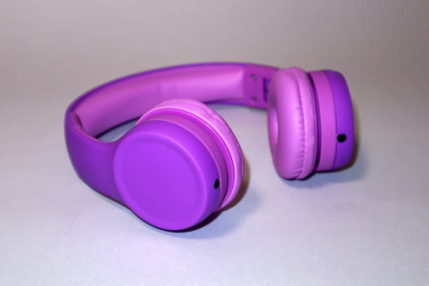 istock Purple headphones on a grey background. 1975940726