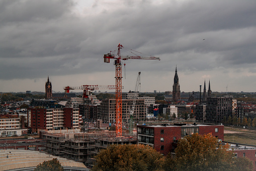 Delft, The Netherlands - October 2021: View on Delft and Rotterdam from an apartment in the Voorhof neighbourhood, with a ton of construction going on .