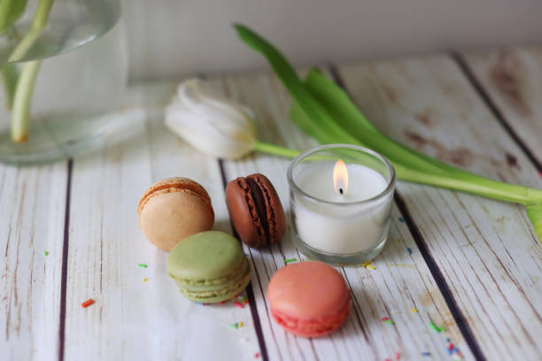 istock Romantic still life with a candle, macarons and tulips 1975975477