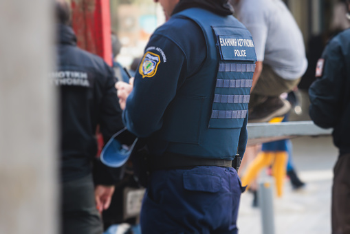 Hellenic Police with Greek Police logo emblem on uniform, Greek police squad on duty maintain public order in the streets of Athens, Attica, Greece, group of policemen