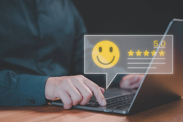 istock Client use a laptop give point with virtual screen on smile face icon for satisfaction in opinion and service. Customer satisfaction survey, service rating online, testimonial feedback review. 1976036257