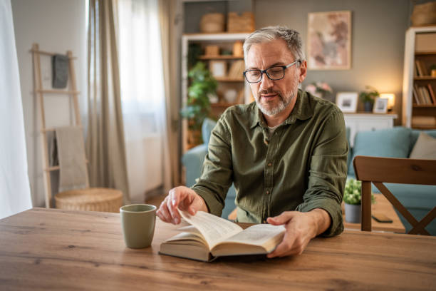 istock A mature man enjoys a quiet moment reading a book 1976055848
