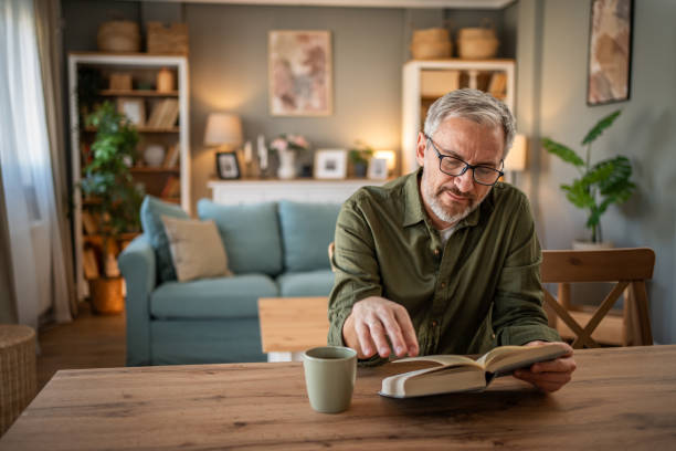 istock A mature man enjoys a quiet moment reading a book 1976056359