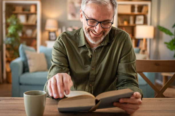 istock A mature man enjoys a quiet moment reading a book 1976056406