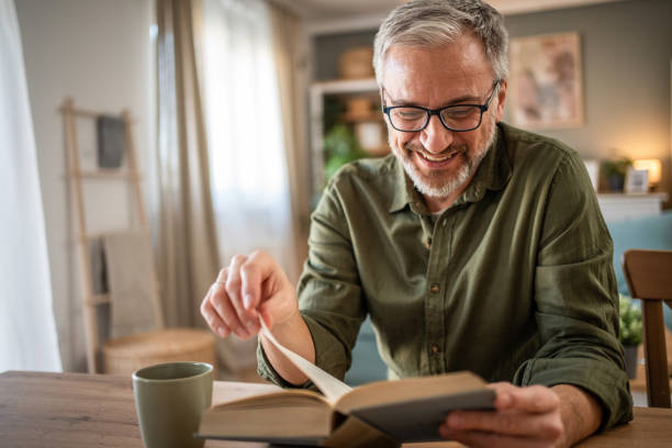 istock A mature man enjoys a quiet moment reading a book 1976056872
