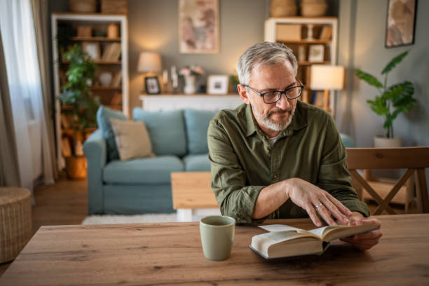 istock A mature man enjoys a quiet moment reading a book 1976056876