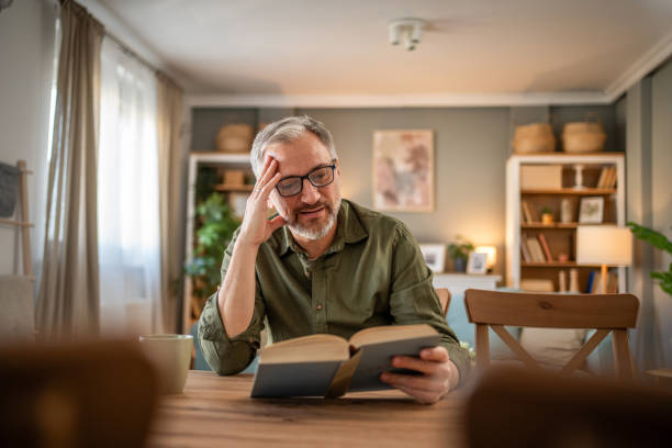 istock A mature man enjoys a quiet moment reading a book 1976058439