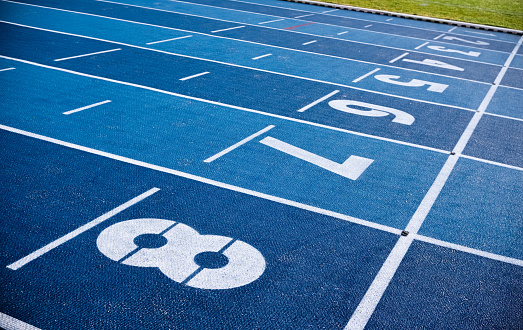Race starting line  white Numbers on blue running track