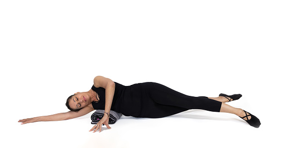 inner thigh pose, in the studio isolated on white. Specialized trauma releasing exercises for elderly people, 55 years old woman trainer posing for exercises.