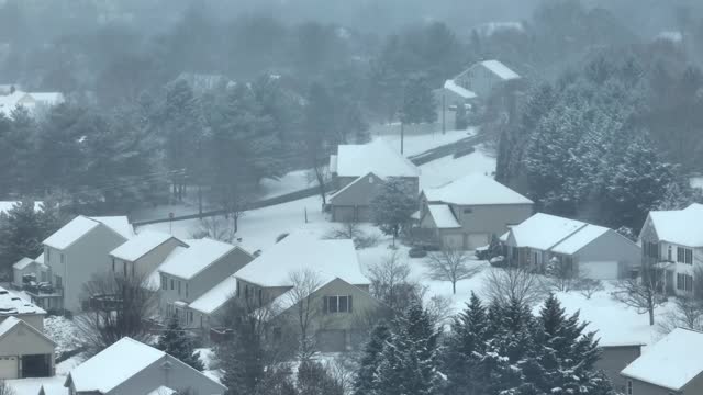 Suburban homes covered in snow. American neighborhood in winter theme.