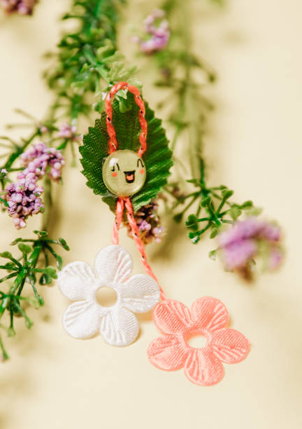 istock One beautiful floral martisor with spring flowers on a yellow background. 1976131152