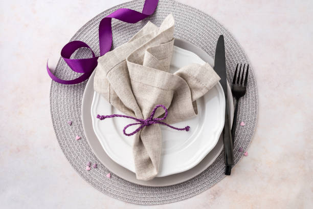 istock Purple and grey romantic arrangement with plates and napkin high angle view on table 1976132733