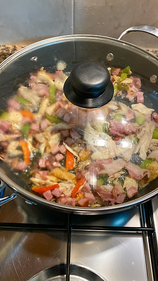 Cooking vegetables and meat in a pan