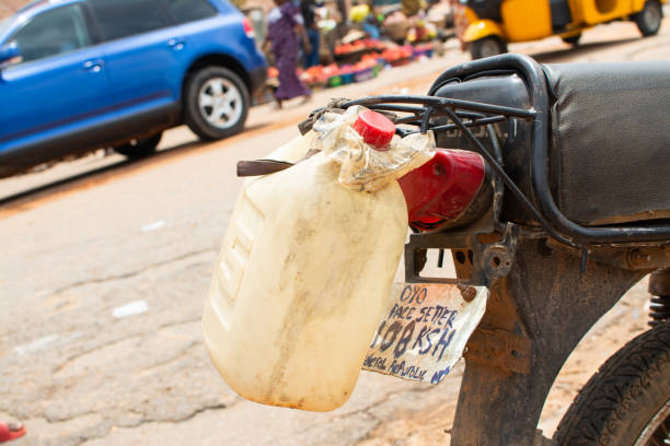 Plastic keg or gallon tied behind a motorcycle 4 April 2017, Ibadan Nigeria: Image captured during Nigerian Photography Classroom group at a photowalk in aimed at vising the Olu Ibadan of Ibadan land in Nigeria. oyo state stock pictures, royalty-free photos & images