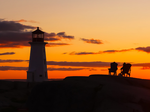 Peggy's Cove, Nova Scotia, Canada - August, 2023: Gorgeous cloudscape over Peggy's Point Lighthouse in the village of Peggy's Cove, a historic fishing town in Nova Scotia, Canada, during a summer sunset in August 2023.