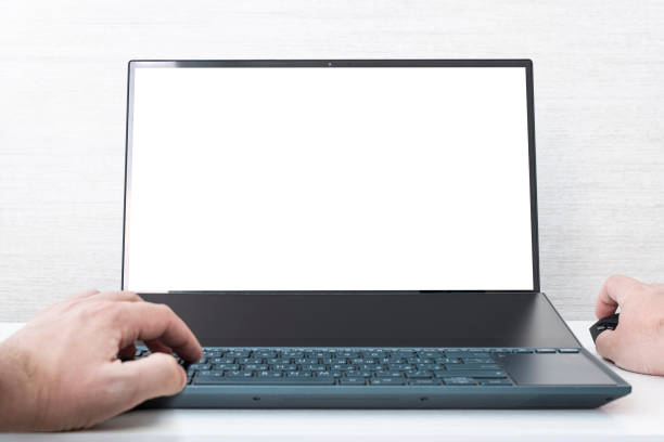istock Mockup image of hand using laptop with blank white screen on white background 1976187812