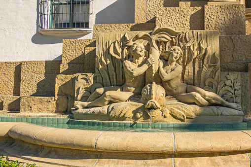 Santa Barbara, CA, USA - November 30, 2023: Santa Barbara County Courthouse Spirit of the Ocean fountain, left part of Great Arch. Sandstone sculpture of male and female couple