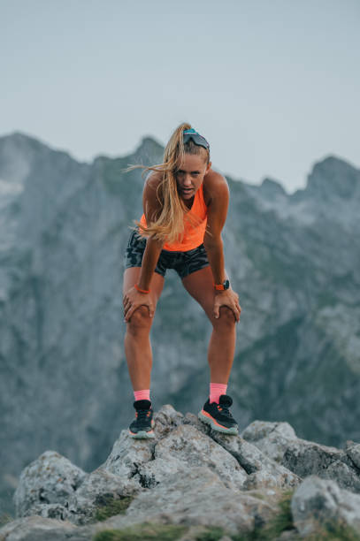 istock An exhausted skyrunner is taking a break after running in mountains. 1976205550