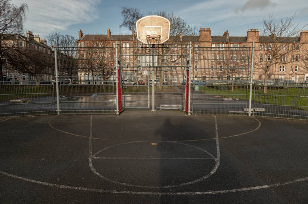 basketball backboard with the hoop metal ring at outdoor basketball courts in the park. - concrete park city cityscape fotografías e imágenes de stock