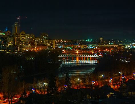 Calgary, Alberta - Canada - November, 2017: Night view on downtown Calgary from Mchugh Bluff, in Crescent Heights, offering one of the best views in town. And from this angle the Peace Bridge can be seen.
