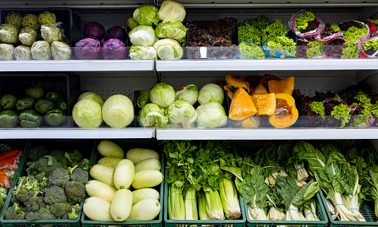 Fresh vegetables on shelves at the supermarket - grocery shopping concepts
