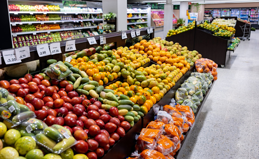 Wide shot of the produce aisle at the supermarket - grocery shopping concepts
