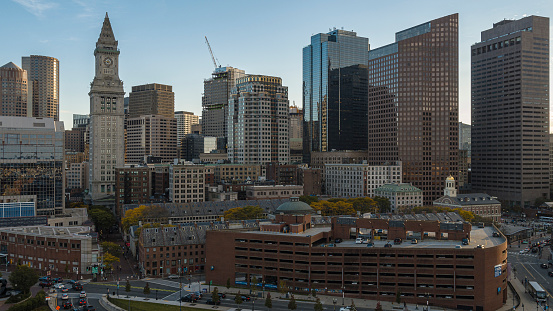 Downtown Boston with the view of Harbor Towers, Custom House Clock Tower and famous Faneuil Hall Marketplace at the front.