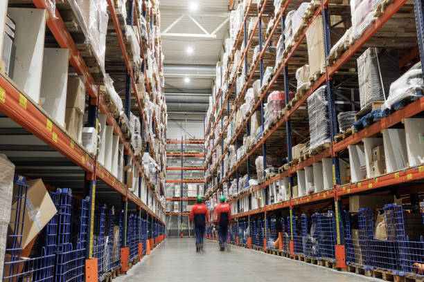 istock Warehouse workers walking along the shelves with goods. Blurred motion effect. 1976227823