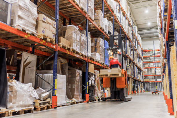 istock Forklift carrying cardboard box in warehouse. 1976227824
