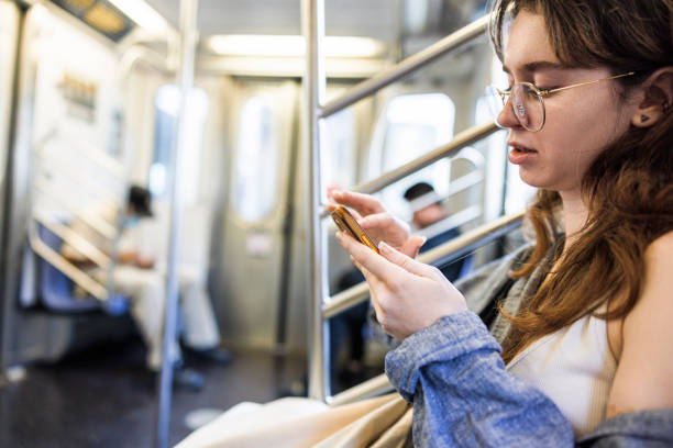 istock Working online in the train. Tired woman with open mouth thinking of some work ideas, using smartphone wireless technology in the train 1976228362