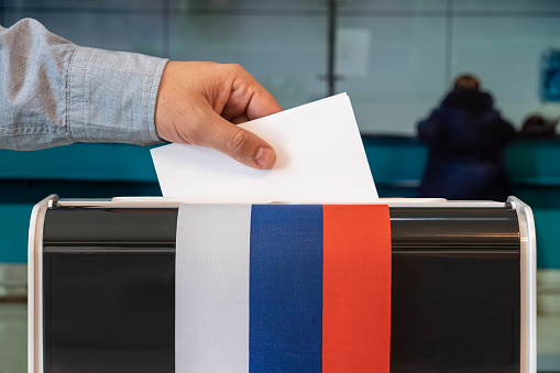 Ballot box textured with Czechoslovakian flag. Isolated on white background. A vote envelope is entering into the ballot box. Horizontal composition with copy space. Great use for referendum and presidential elections related concepts. Clipping path is included.