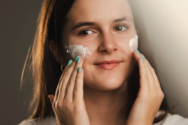 istock Young Girl Applying Face Cream 1976279153