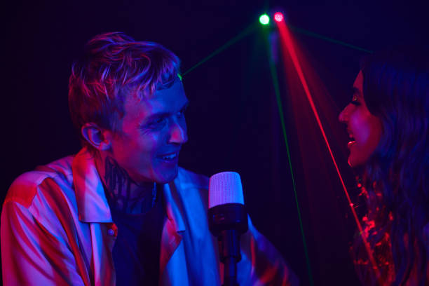 istock Couple Enjoying Singing in Karaoke 1976287214