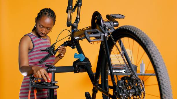 istock Expert uses screwdriver to tighten brake levers on bicycle, examining components 1976323166