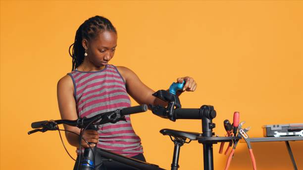 istock Happy repairman securing bicycle on repair stand before patching up components 1976326868