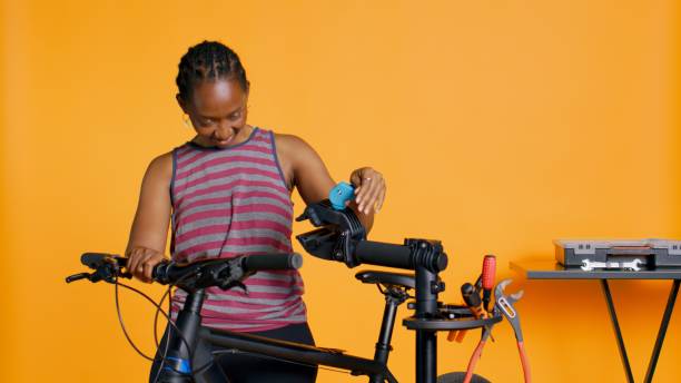 istock Engineer setting up bike repair stand, using it to adjust derailleur 1976329923