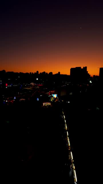 twilight horizon over urban cityscape with silhouetted buildings and fading light