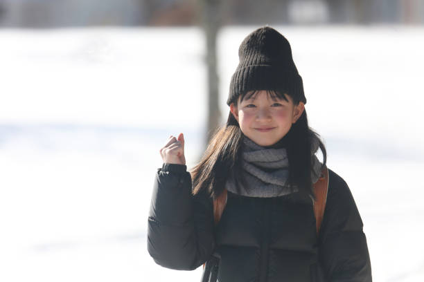 Smiling girl carrying a school bag