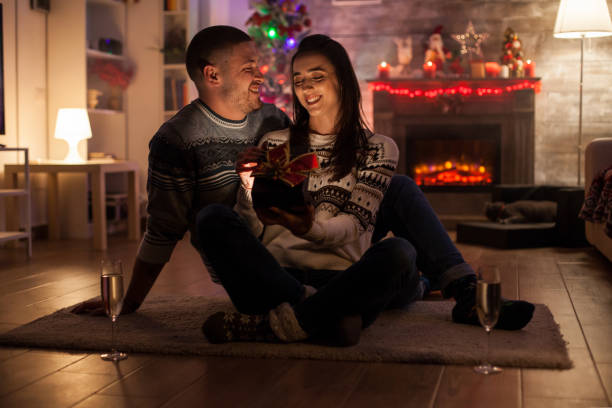 istock Smiling couple in dark living room 1976465675