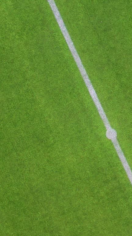 Aerial view of a soccer field center circle and midline on a bright day