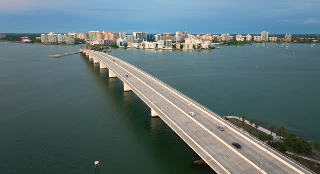 Sarasota city downtown at sunset. Ringling Bridge and expensive waterfront high-rise buildings in Florida. Urban travel destination in the USA
