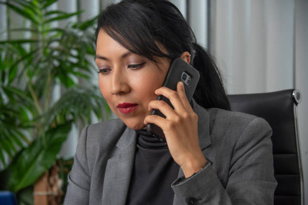 istock Latina entrepreneur using her cell phone for business and networking calls 1976499940