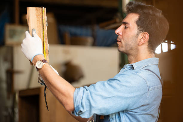 istock Carpenter working at his carpentry shop. Eyesight is utilized to ensure accuracy. 1976553317