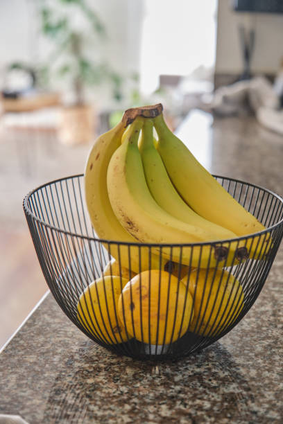 istock Basket with delicious fruits on table in kitchen, decorative kitchen interior. 1976573009