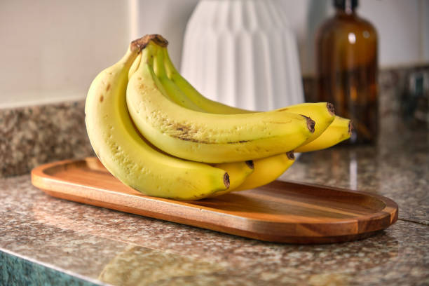 istock Basket with delicious fruits on table in kitchen, decorative kitchen interior. 1976573520