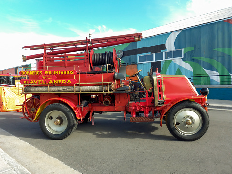 Avellaneda, Argentina - Jun 4, 2022: Old red 1921 Renault fire truck. First pumper tanker in Argentina. Classic car show. Side view. Copy space.