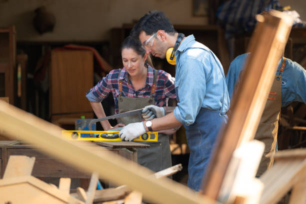 istock Carpenter and his assistant working together in a carpentry workshop 1976614267